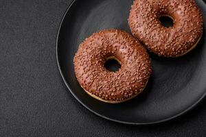 Delicious chocolate glazed donut sprinkled with chocolate chips photo