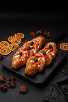 Delicious fresh crispy pastry in the form of a pigtail with strawberries and blueberries photo