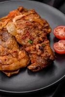 Delicious fried chicken in sauce with onions, salt, spices and herbs photo