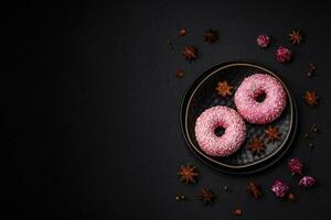 Delicious fresh sweet donuts in pink glaze with strawberry filling photo