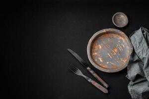 Empty wooden plate, knife, fork and cutting board photo