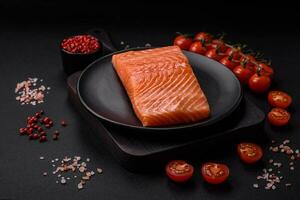 Fresh raw salmon red fish fillet with salt and spices photo