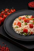 Delicious boiled rice with peppers, peas, asparagus beans and carrots photo