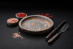 Empty wooden plate, knife, fork and cutting board photo