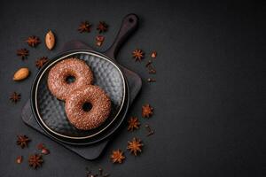 Delicious chocolate glazed donut sprinkled with chocolate chips photo