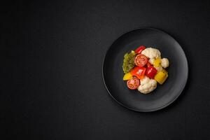 Delicious fresh salad of broccoli, cauliflower, sweet peppers and cherry tomatoes photo