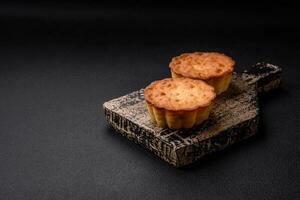 Delicious baked cupcake or tartlet with cheese and raisins photo