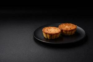 Delicious baked cupcake or tartlet with cheese and raisins photo
