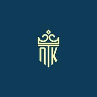 NK initial monogram shield logo design for crown vector image