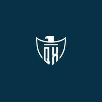 QX initial monogram logo for shield with eagle image vector design