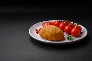 Delicious baked cutlet breaded with spices, salt and herbs photo