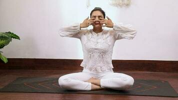 Video of a woman performing Bhramari Pranayama