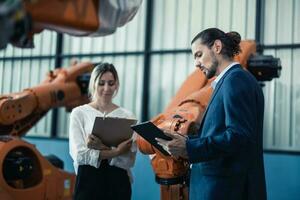 Robotic factory owner explain, discuss functionality and performance of robot systems with client. Answering questions about after-sales service. Price negotiation. Developing long-term relationships photo