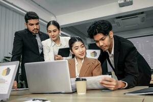 Financial advisors collaborate to assess a company's financial performance using data from its operational activities. Team members work together in a discussions meeting to develop a business plan. photo