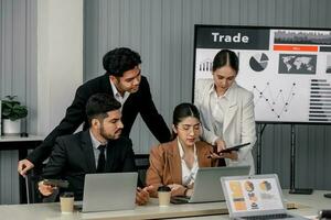 Financial advisors collaborate to assess a company's financial performance using data from its operational activities. Team members work together in a discussions meeting to develop a business plan. photo