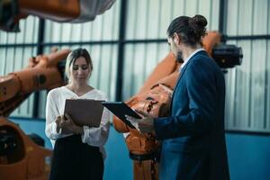 Robotic factory owner explain, discuss functionality and performance of robot systems with client. Answering questions about after-sales service. Price negotiation. Developing long-term relationships photo