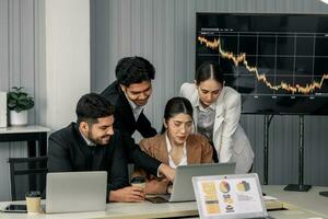 Financial advisors collaborate to assess a company's financial performance using data from its operational activities. Team members work together in a discussions meeting to develop a business plan. photo