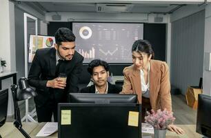 Financial advisors collaborate to assess a company's financial performance using data from its operational activities. Team members work together in a discussions meeting to develop a business plan. photo