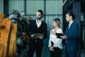 Robotic factory owner explain, discuss functionality and performance of robot systems with client. Answering questions about after-sales service. Price negotiation. Developing long-term relationships photo