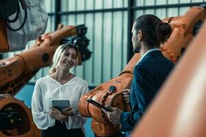Robotic factory owner explain, discuss functionality and performance of robot systems with client. Answering questions about after-sales service. Price negotiation. Developing long-term relationships photo