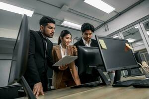 Financial advisors collaborate to assess a company's financial performance using data from its operational activities. Team members work together in a discussions meeting to develop a business plan. photo