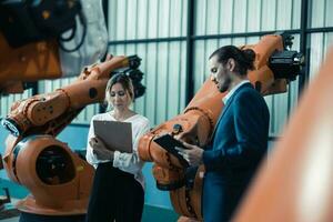 Robotic factory owner explain, discuss functionality and performance of robot systems with client. Answering questions about after-sales service. Price negotiation. Developing long-term relationships photo