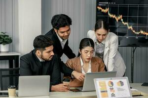 Financial advisors collaborate to assess a company's financial performance using data from its operational activities. Team members work together in a discussions meeting to develop a business plan. photo