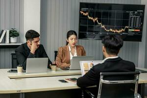 Financial advisors collaborate to assess a company's financial performance using data from its operational activities. Team members work together in a discussions meeting to develop a business plan. photo