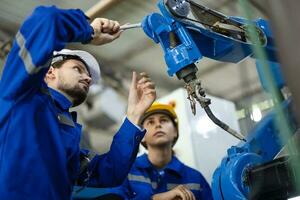 Robotic technicians tighten and loosen components with screwdriver and plier to perform safety maintenance. Measuring current, voltage, resistance, capacity, temperature with digital clamp meter. photo