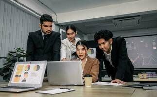 Financial advisors collaborate to assess a company's financial performance using data from its operational activities. Team members work together in a discussions meeting to develop a business plan. photo
