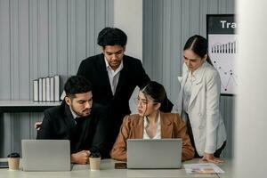 Financial advisors collaborate to assess a company's financial performance using data from its operational activities. Team members work together in a discussions meeting to develop a business plan. photo