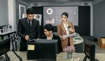 Financial advisors collaborate to assess a company's financial performance using data from its operational activities. Team members work together in a discussions meeting to develop a business plan. photo