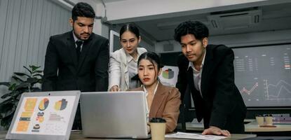 Financial advisors collaborate to assess a company's financial performance using data from its operational activities. Team members work together in a discussions meeting to develop a business plan. photo