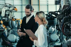 Robotic factory owner explain, discuss functionality and performance of robot systems with client. Answering questions about after-sales service. Price negotiation. Developing long-term relationships photo