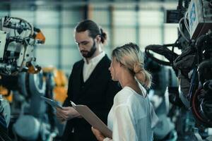 Robotic factory owner explain, discuss functionality and performance of robot systems with client. Answering questions about after-sales service. Price negotiation. Developing long-term relationships photo