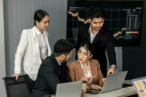 Financial advisors collaborate to assess a company's financial performance using data from its operational activities. Team members work together in a discussions meeting to develop a business plan. photo