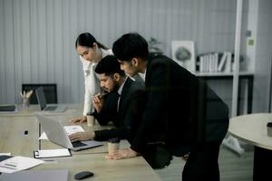 Financial advisors collaborate to assess a company's financial performance using data from its operational activities. Team members work together in a discussions meeting to develop a business plan. photo