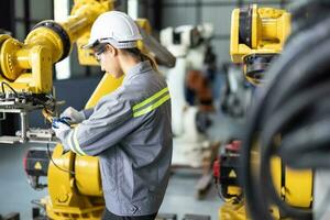 Robotic technicians tighten and loosen components with screwdriver and plier to perform safety maintenance. Measuring current, voltage, resistance, capacity, temperature with digital clamp meter. photo