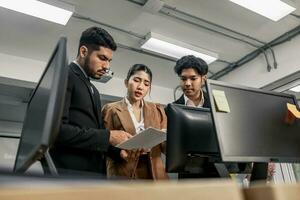 Financial advisors collaborate to assess a company's financial performance using data from its operational activities. Team members work together in a discussions meeting to develop a business plan. photo