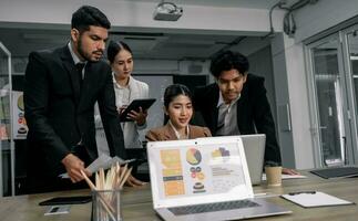 Financial advisors collaborate to assess a company's financial performance using data from its operational activities. Team members work together in a discussions meeting to develop a business plan. photo