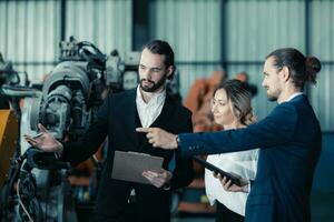 Robotic factory owner explain, discuss functionality and performance of robot systems with client. Answering questions about after-sales service. Price negotiation. Developing long-term relationships photo