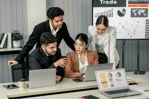Financial advisors collaborate to assess a company's financial performance using data from its operational activities. Team members work together in a discussions meeting to develop a business plan. photo