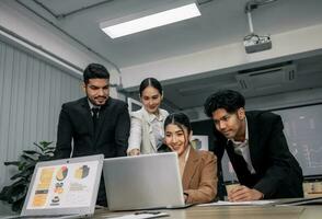 Financial advisors collaborate to assess a company's financial performance using data from its operational activities. Team members work together in a discussions meeting to develop a business plan. photo