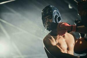 Boxer utilizar varios puñetazo combinaciones, incluso el pinchazo, gancho, uppercut, cruz, balancearse, derecho. consiguiendo en cerca a hacer adversario en cuerdas y knockear. boxeo campeones ganar el redondo en boxeo anillo foto