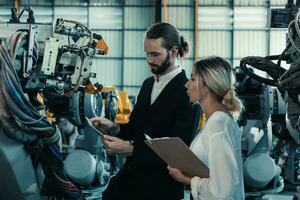Robotic factory owner explain, discuss functionality and performance of robot systems with client. Answering questions about after-sales service. Price negotiation. Developing long-term relationships photo