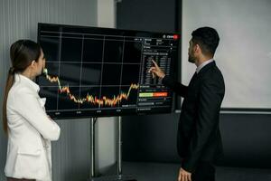 Financial advisors collaborate to assess a company's financial performance using data from its operational activities. Team members work together in a discussions meeting to develop a business plan. photo
