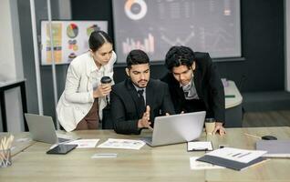 Financial advisors collaborate to assess a company's financial performance using data from its operational activities. Team members work together in a discussions meeting to develop a business plan. photo