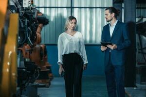 Robotic factory owner explain, discuss functionality and performance of robot systems with client. Answering questions about after-sales service. Price negotiation. Developing long-term relationships photo