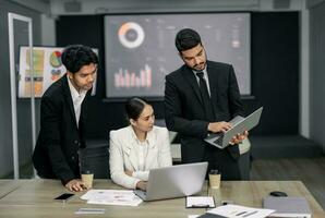 Financial advisors collaborate to assess a company's financial performance using data from its operational activities. Team members work together in a discussions meeting to develop a business plan. photo