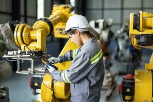 Robotic technicians tighten and loosen components with screwdriver and plier to perform safety maintenance. Measuring current, voltage, resistance, capacity, temperature with digital clamp meter. photo